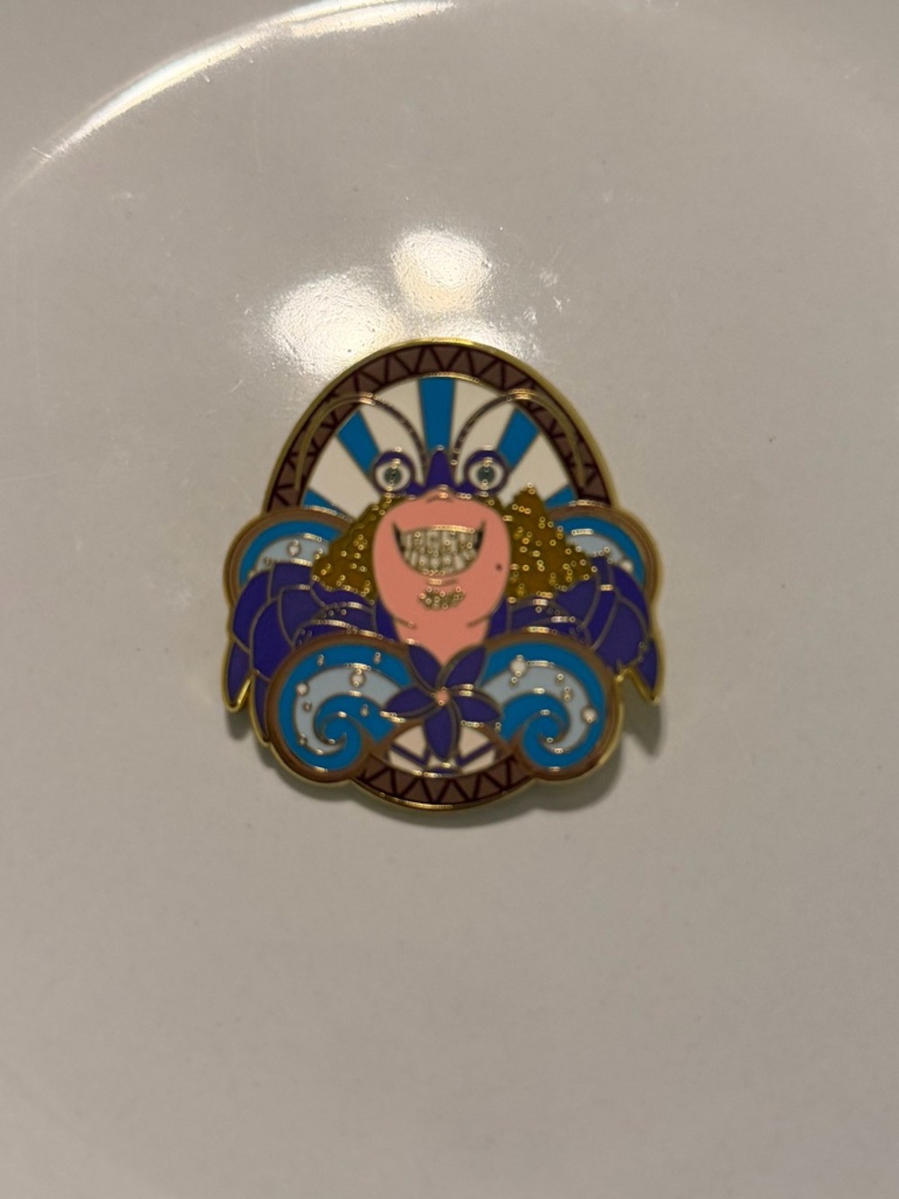 This Disney enamel pin features the character Tamatoa from Disney's Moana
